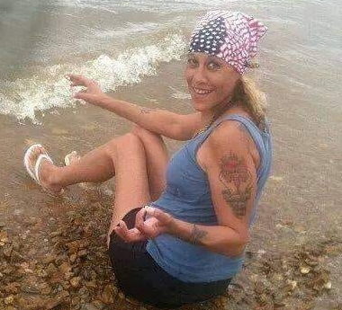 An image of a woman sat on a beach